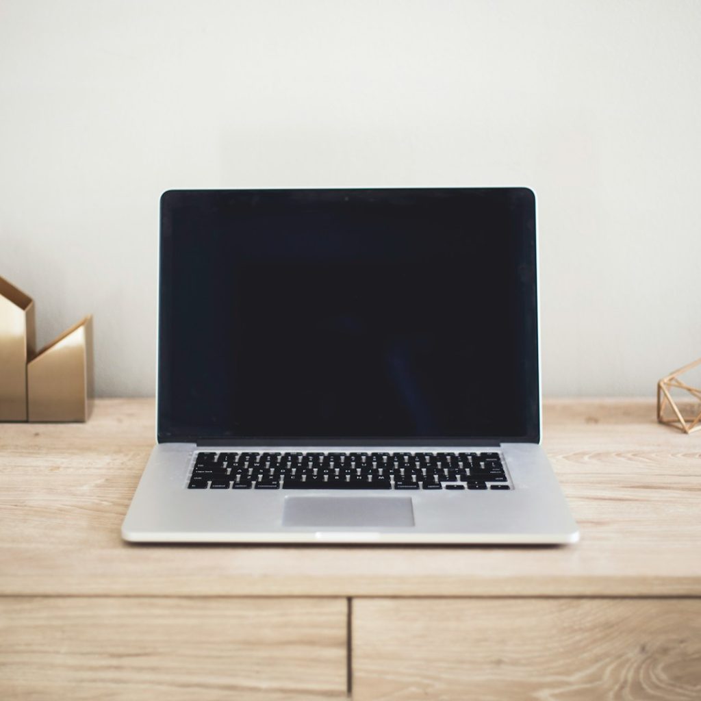 MacBook Pro on top of brown table